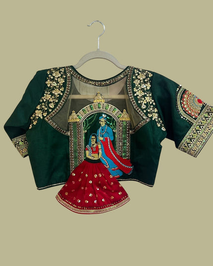 House Of Indian Wedding Attire deep green blouse with gold embroidery, sequins, and royal couple motif on sheer back panel.