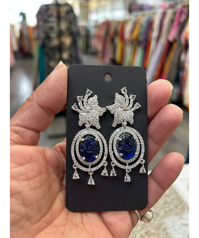 Kurti Connection USA oval deep blue gemstone dangle earrings with cubic zirconia halo and floral top.