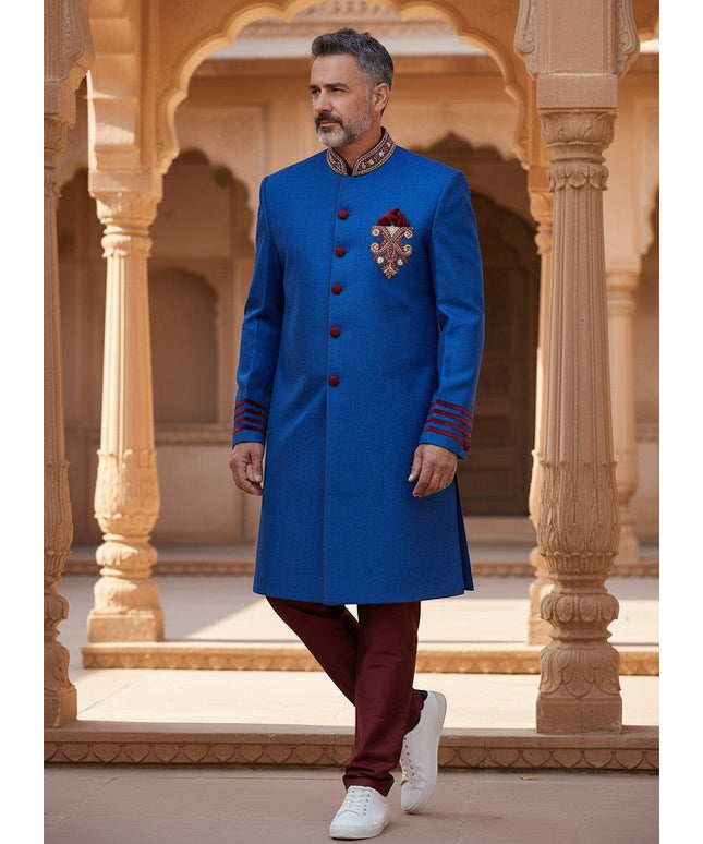 Kurti Connection USA blue sherwani jacket with red velvet accents, mandarin collar, and embroidery, worn by a man.