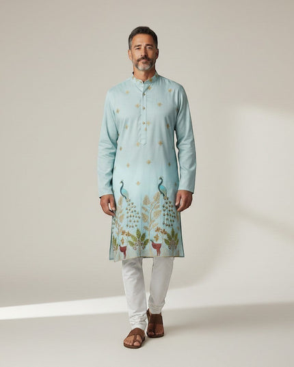 Kurti Connection USA light blue silk kurta set with intricate peacock embroidery and gold accents, paired with white pajama.