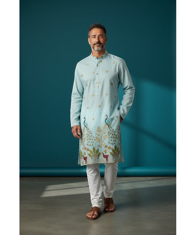 Kurti Connection USA light blue silk kurta set with intricate peacock and deer embroidery, paired with white pajama.