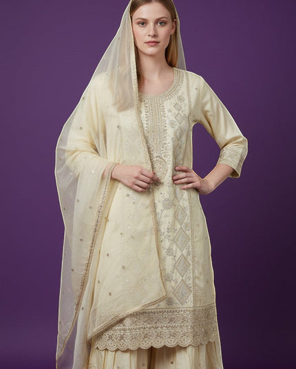 Kurti Connection USA cream silk blend kurti sharara set with silver embroidery and sequin dupatta.