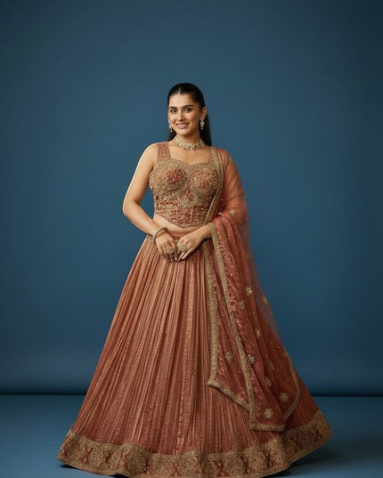 Kurti Connection USA embroidered lehenga and blouse set in warm rust with gold detailing. Sleeveless blouse and pleated skirt.