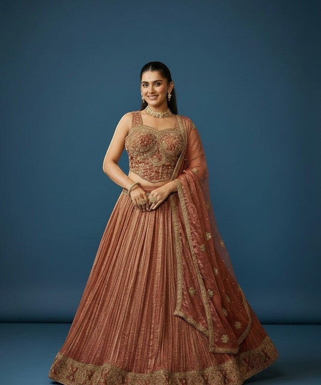 Kurti Connection USA embroidered lehenga and blouse set in warm rust with gold detailing. Sleeveless blouse and pleated skirt.