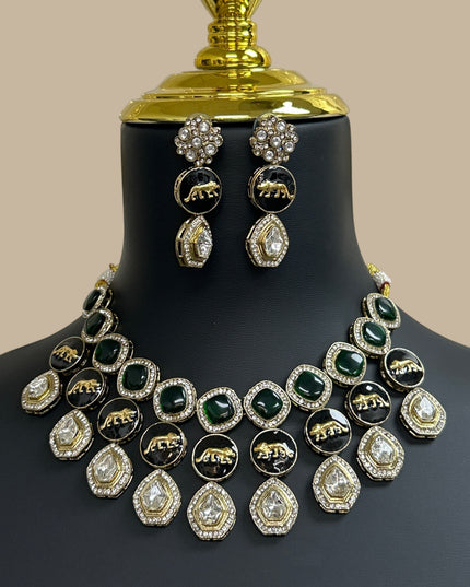Kurti Connection USA multi-layered necklace and earring set with emerald green stones, black animal motifs, and gold.