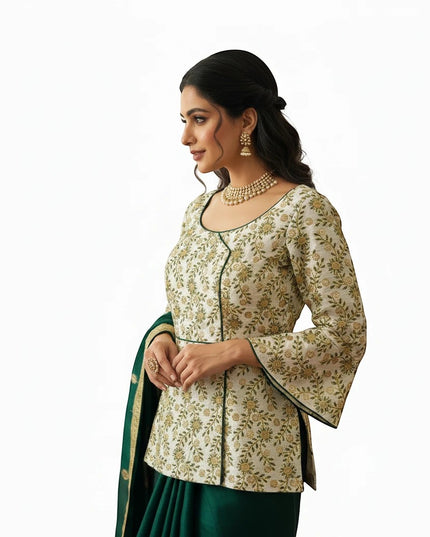 Kurti Connection USA long blouse in cream with floral embroidery, bell sleeves, and green trim worn with a lehenga