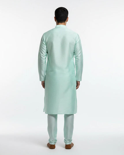 Back view of a man wearing a Kurti Connection USA mint green traditional kurta pajama set with a mandarin collar.