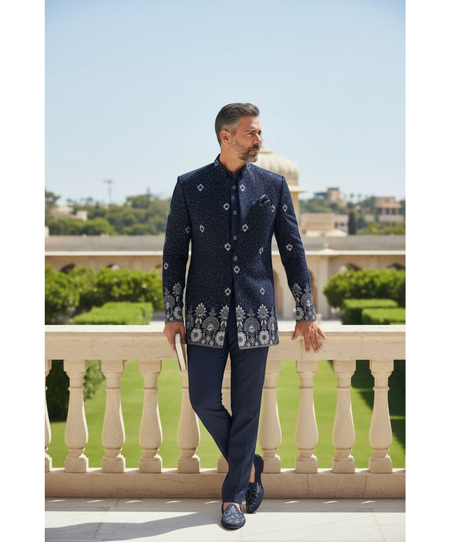 Kurti Connection USA navy blue embroidered Bandhgala suit with silver and white floral embroidery on collar, cuffs, and hem. Model wears tailored fit.