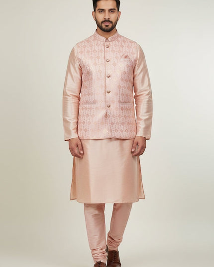 Man wearing a Kurti Connection USA peach kurta set with a patterned Nehru jacket and mandarin collar for formal events.