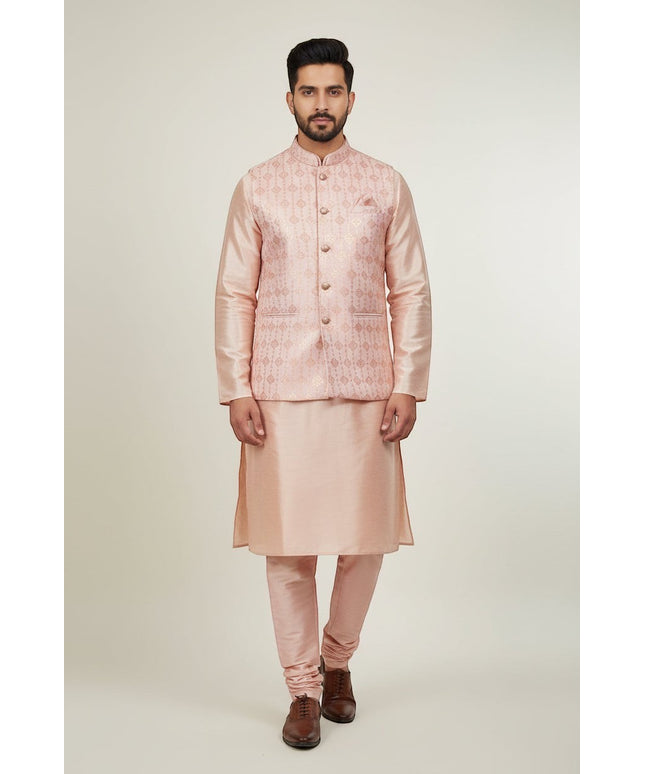 Man wearing a Kurti Connection USA peach kurta set with a patterned Nehru jacket and matching trousers