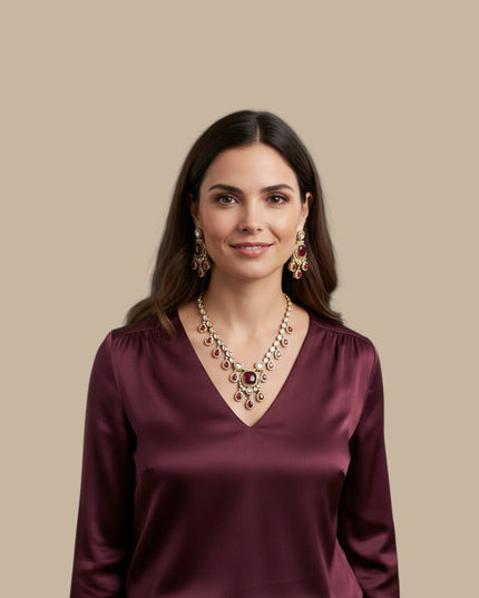 Kurti Connection USA ethnic jewelry set with ruby-red stones and antique-gold finish worn by a woman in a silk top.