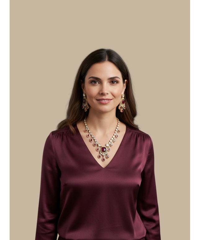 Kurti Connection USA ethnic jewelry set with ruby-red stones and antique-gold finish worn by a woman in a silk top.