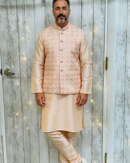 Man wearing a Kurti Connection USA silk kurta pajama set with a patterned light pink Nehru jacket