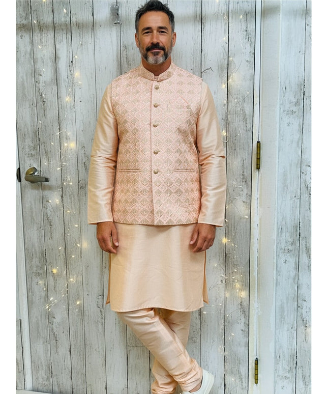 Man wearing a Kurti Connection USA silk kurta pajama set with a patterned light pink Nehru jacket