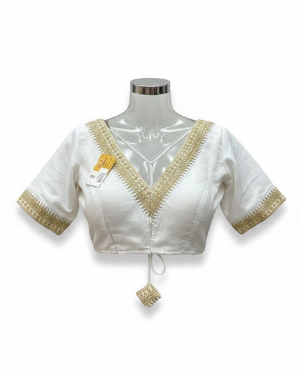 Kurti Connection USA white ethnic blouse with V-neck, half-sleeves, and intricate gold embroidery detailing.